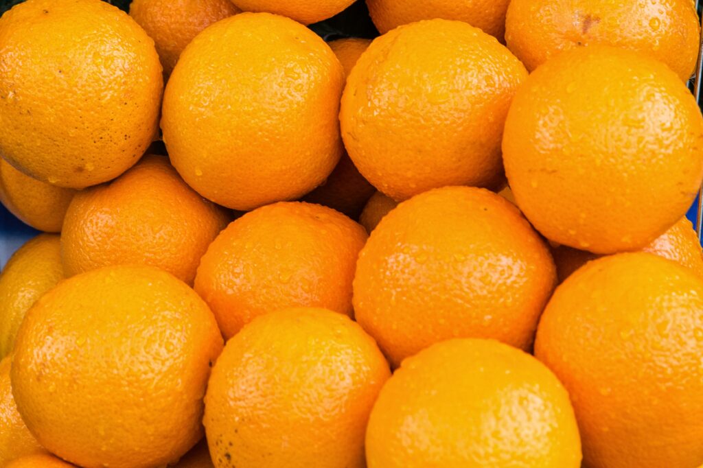 A vibrant close-up of fresh oranges showcasing their natural texture and color.